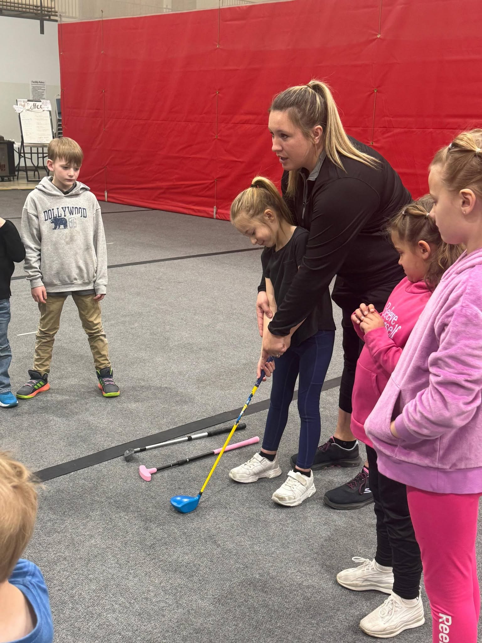 Tiny Tees participant learning golf basics