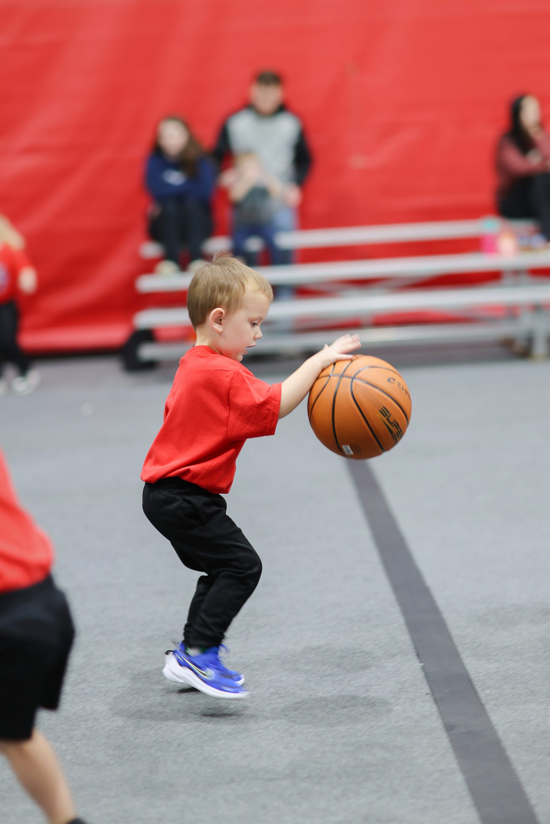 Young child practicing basketball at Biddy Basketball
